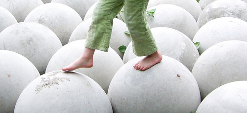 Free Child Walking On White Round Spheres Balance